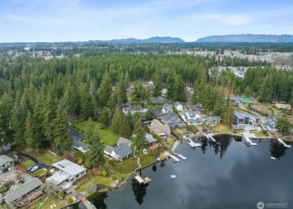 Aerial view of a serene lake in Black Diamond, WA, with homes lining the shore and lush forest surrounding, perfect for Junk Removal in Black Diamond WA.