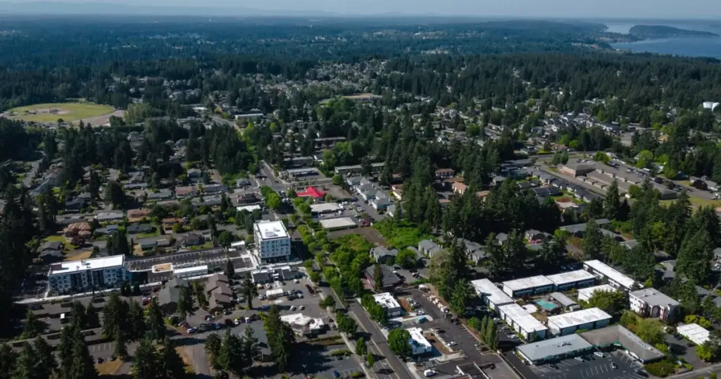 Scenic aerial view of University Place, WA, with residential areas, commercial buildings, and lush greenery, showcasing the town's landscape and Junk Removal in University Place WA.