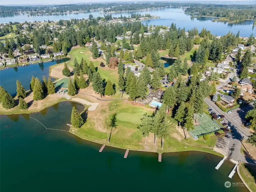Aerial view of Lake Tapps, WA, showcasing a golf course, green spaces, residential homes, and scenic waterfront. Junk Removal in Lake Tapps, WA services available.