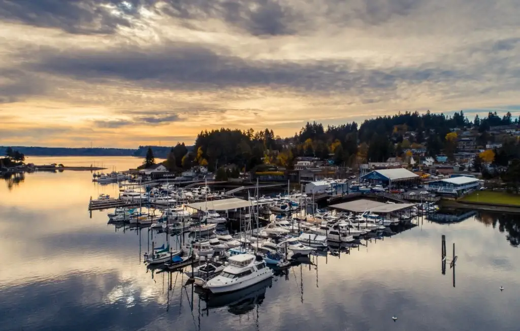 A serene view of the marina in Gig Harbor, WA, with boats docked at sunset, reflecting on the calm water and Junk Removal in Gig Harbor WA.